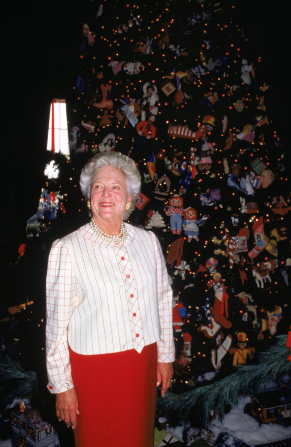 Barbara Bush stands next to a Christmas tree at the White House in 1991.
