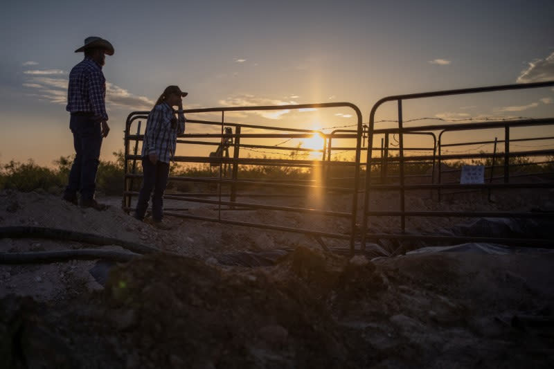 Ranchers approach toxic pit collecting produced water from well blowout in Pecos County, Texas