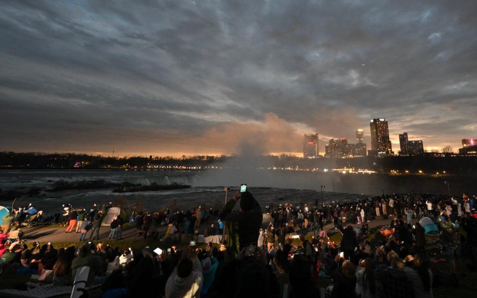 Skies darken across Niagara Falls as the sun is blotted out