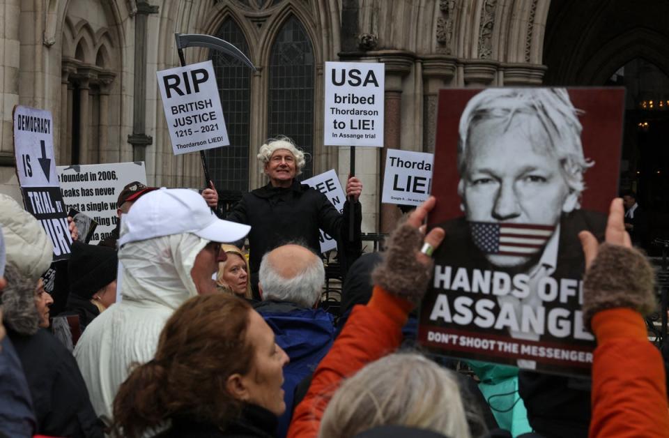 Demonstrators protested outside of the Royal Courts of Justice as the hearing took place on Wednesday (AFP)