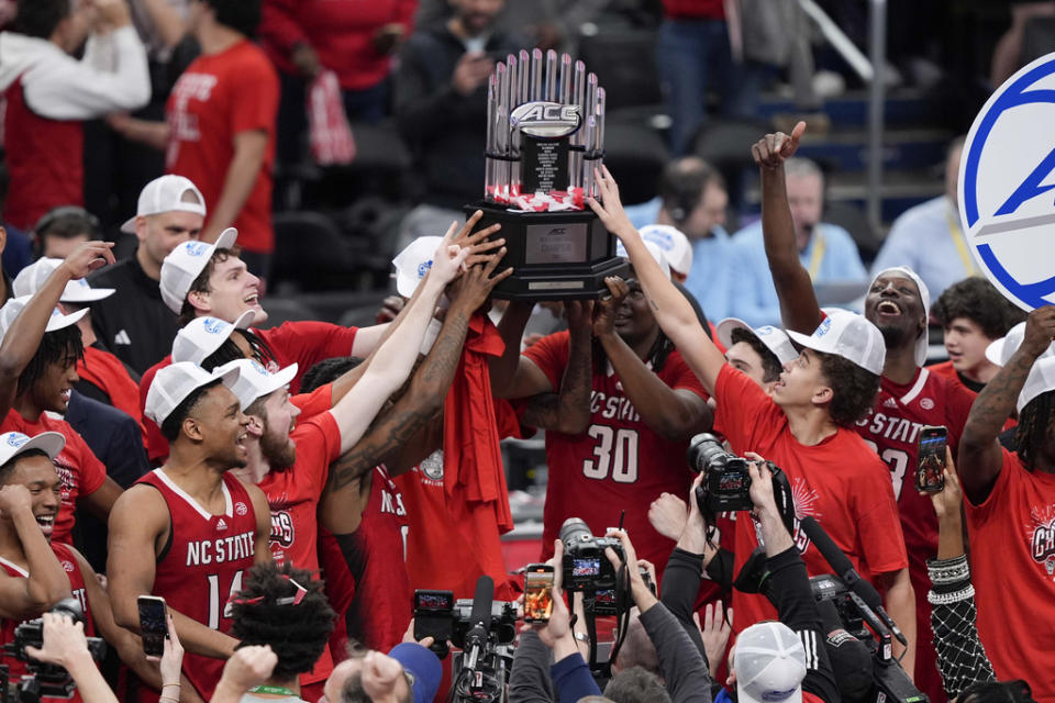 North Carolina State hoists the trophy after winning an NCAA college basketball game against North Carolina to win the championship of the Atlantic Coast Conference tournament, Saturday, March 16, 2024, in Washington. North Carolina State won 84-76. (AP Photo/Susan Walsh)