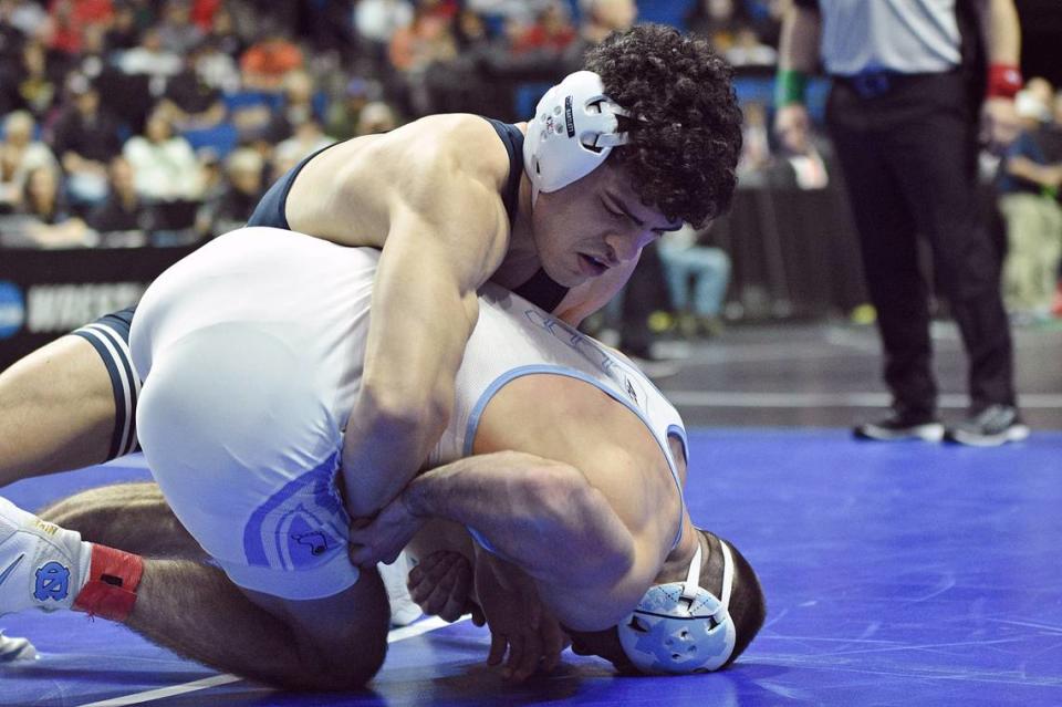 Penn State’s Beau Bartlett controls North Carolina’s Lachlan McNeil in their 141-pound consolation finals match of the NCAA Championships on Saturday, March 18, 2023 at the BOK Center in Tulsa, Okla. Bartlett beat McNeil, 4-2, to finish third.