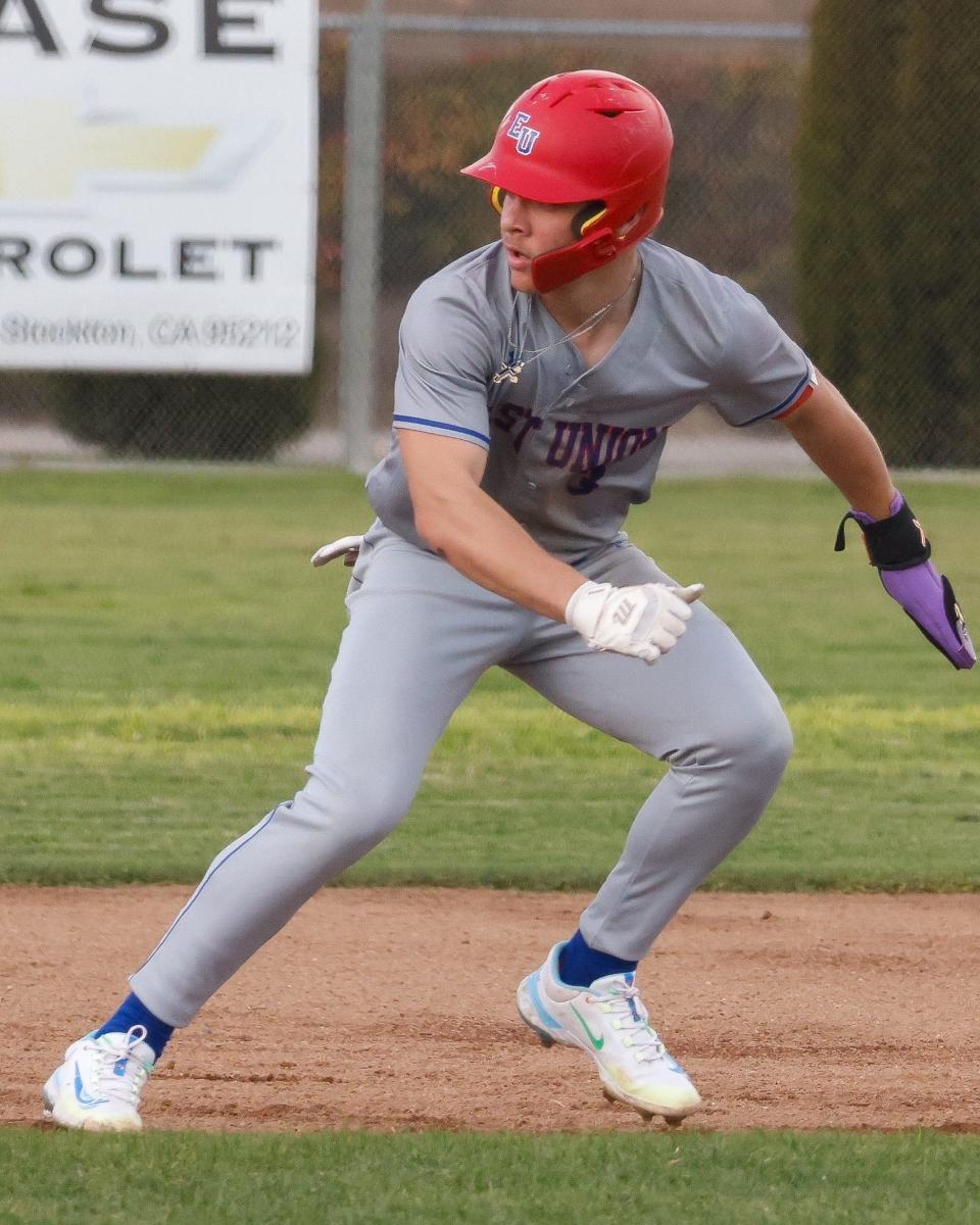 East Union baserunner Blake Mount looks back to find the ball while in a run-down during a game between Weston Ranch and East Union High at Weston Ranch High School in Stockton, CA