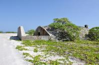 A World War II-era bunker is seen by a beach on Wake Island