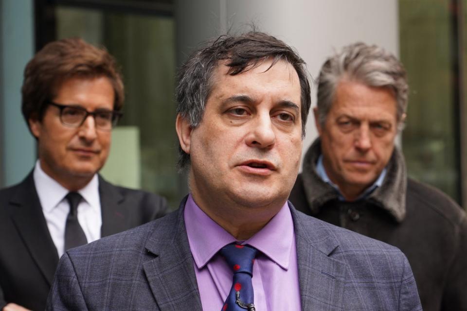 Actor Hugh Grant (right) with David Sherborne (left) outside the Rolls Building in central London, where they were supporting campaigner Dr Evan Harris (centre) (PA Wire)