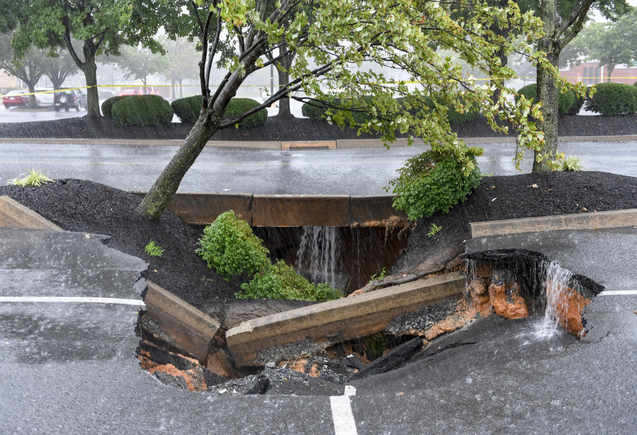 A sinkhole formed in the Berkshire Square Shopping Center parking lot in Wyomissing, Penn., on Wednesday afternoon. 
