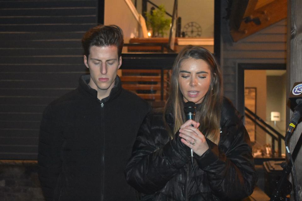 The Rev. Dylan Chicoine and his wife, Gabriele Chicoine, offer prayers for Dee Warner and her family during a vigil Saturday for the missing Tipton woman and her brother Gregg Hardy's farm near her home. They are pastors at The Storehouse Church in Adrian.