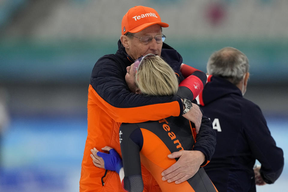 Irene Schouten of the Netherlands reacts with a coach after winning the gold medal and breaking the Olympic record in the women's speedskating 3,000-meter race at the 2022 Winter Olympics, Saturday, Feb. 5, 2022, in Beijing.(AP Photo/Ashley Landis)