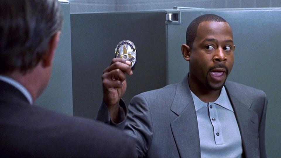 Martin Lawrence holding up a police badge