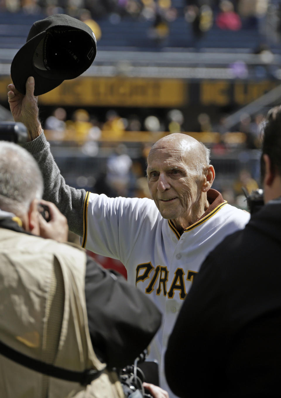 FILE - Former Pittsburgh Pirates shortstop Dick Groat, center, acknowledges fans at PNC Park during a pregame ceremony honoring his lifetime of service to the Pirates organization, before a baseball game against the St. Louis Cardinals in Pittsburgh, Monday, April 1, 2019. Groat, a two-sport star who went from All-American guard in basketball to a brief stint in the NBA to ultimately an All-Star shortstop and the 1960 National League MVP while playing baseball for his hometown Pittsburgh Pirates, has died. He was 92. Groat's family said in a statement that Groat died early Thursday morning, April 27, 2023, at UMPC Presbyterian Hospital due to complications from a stroke. (AP Photo/Gene J. Puskar, File)