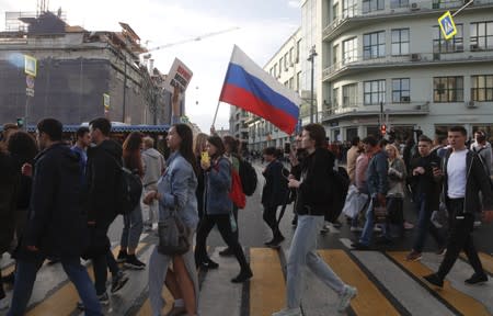 Participants of a procession are seen after a rally to demand authorities allow opposition candidates to run in a local election in Moscow