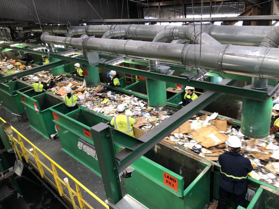 Workers pull out non-recyclable material at a sorting facility in San Francisco | Alana Semuels/TIME