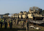 FILE - Members of the US Army's 1st Armoured Battalion of the 9th Regiment, 1st Division from Fort Hood in Texas prepare to unload Bradley Infantry Fighting Vehicles from rail cars as they arrive at the Pabrade railway station some 50 km (31 miles) north of the capital Vilnius, Lithuania, Monday, Oct. 21, 2019. NATO responded to Russia's 2014 annexation of Ukraine's Crimean Peninsula by beefing up alliance forces and conducting drills on the territories of its easternmost members _ the maneuvers the Kremlin described as a security threat. (AP Photo/Mindaugas Kulbis, File)