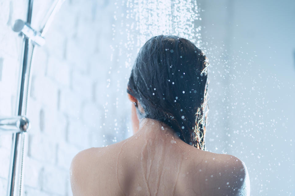 Asian woman taking a shower the back of her picture