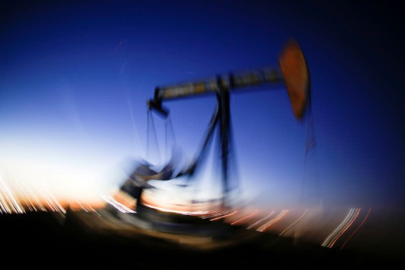 FILE PHOTO: A long exposure image shows the movement of a crude oil pump jack in the Permian Basin in Loving County