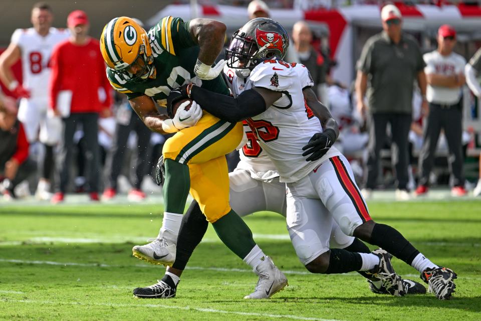 Tampa Bay Buccaneers' Devin White stops Green Bay Packers' AJ Dillon during the first half of an NFL football game Sunday, Sept. 25, 2022, in Tampa, Fla. (AP Photo/Jason Behnken)