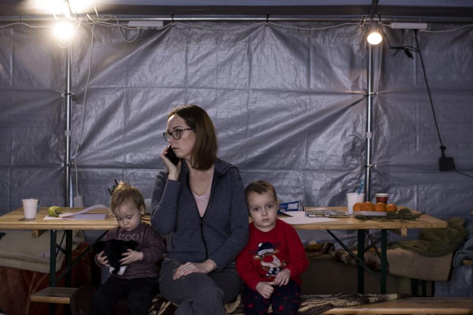 Malvina and her son Pavlo, four, and daughter Yasia, two, in the Caritas (a partner of CAFOD) tent at the Kroscienko border, Poland (Toby Madden/DEC/PA) (PA Media)