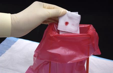 A soiled bandage is disposed of into a bio-hazard waste container in a 2004 archive photo provided by the Centers for Disease Control and Prevention (CDC) in Atlanta. REUTERS/CDC/Jim Gathany/Handout via Reuters/Files