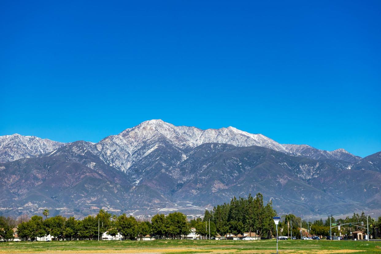 Rancho Cucamonga, CA, USA – February 6, 2021: View of the snowcapped San Gabriel Mountains as seen from Foothill Boulevard in Rancho Cucamonga, California.