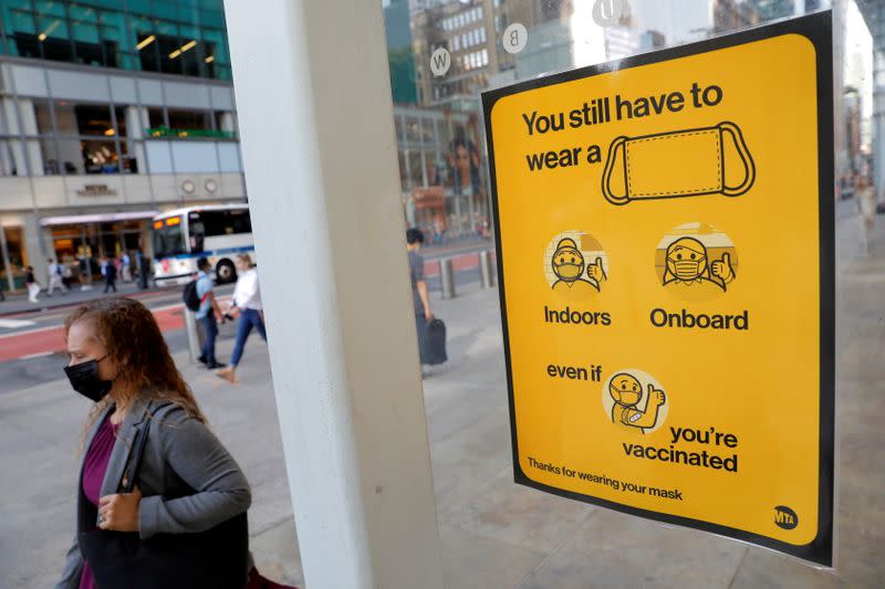 FILE PHOTO: A poster alerting for the wearing of masks is seen on a 42nd Street subway entrance as cases of the infectious coronavirus Delta variant continue to rise in New York City