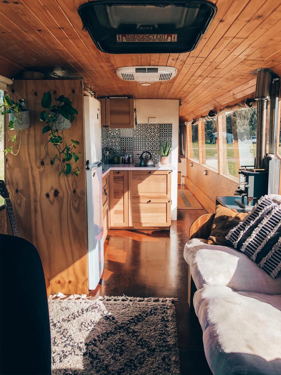 The interior of Marte Snorresdotter Rovik's school bus with wood cabinetry and ceiling