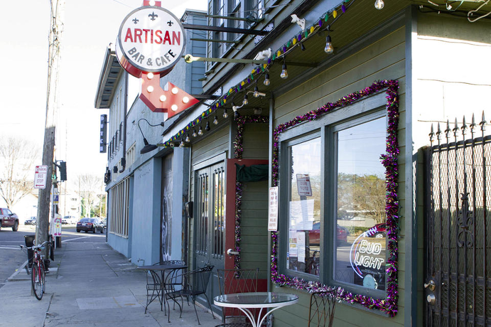 A bike sits outside Artisan Bar and Cafe on St. Claude Avenue on Jan. 30, 2021, in New Orleans. The toll of this year’s toned-down Mardi Gras is evident on St. Claude Avenue, an off-the-beaten-track stretch that has become a destination in recent years. (AP Photo/Dorthy Ray)