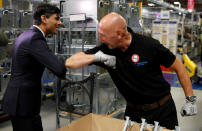 Chancellor of the Exchequer Rishi Sunak greets an employee during a visit to the Worcester Bosch factory in Worcester, central England, on July 9, 2020. - The UK government on on July 8 committed £30 billion ($37 billion, 33 billion euros) to saving jobs and helping the young find work in an economy ravaged by the coronavirus pandemic. Delivering a mini-budget to parliament, finance minister Rishi Sunak announced bonuses to companies retaining staff and taking on apprentices, investment in eco-friendly jobs and even allowing Britons to enjoy discounted meals in some restaurants. (Photo by PHIL NOBLE / POOL / AFP) (Photo by PHIL NOBLE/POOL/AFP via Getty Images)