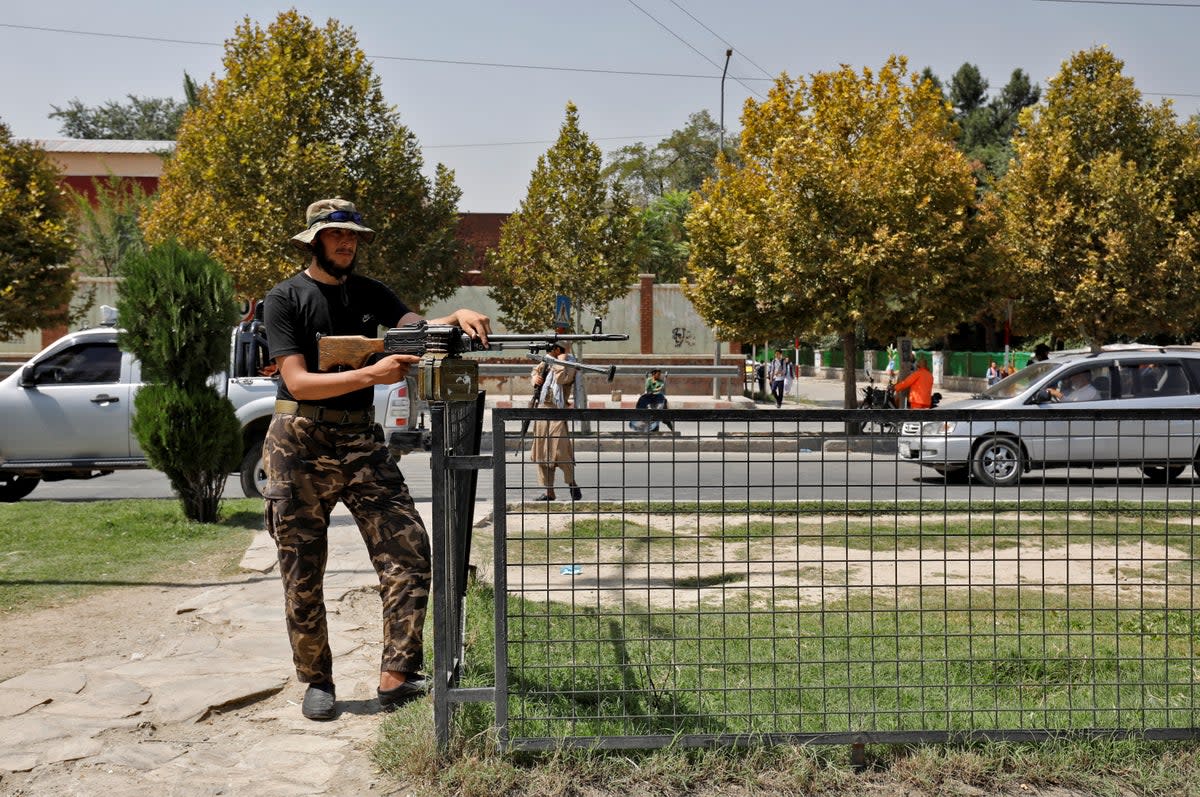 A Taliban fighter stands guard after a blast in front of the Russian embassy (REUTERS)