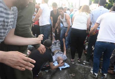 An injured man receives first aid after an explosion during an election rally of pro-Kurdish Peoples' Democratic Party (HDP) in Diyarbakir, Turkey, June 5, 2015. REUTERS/Stringer