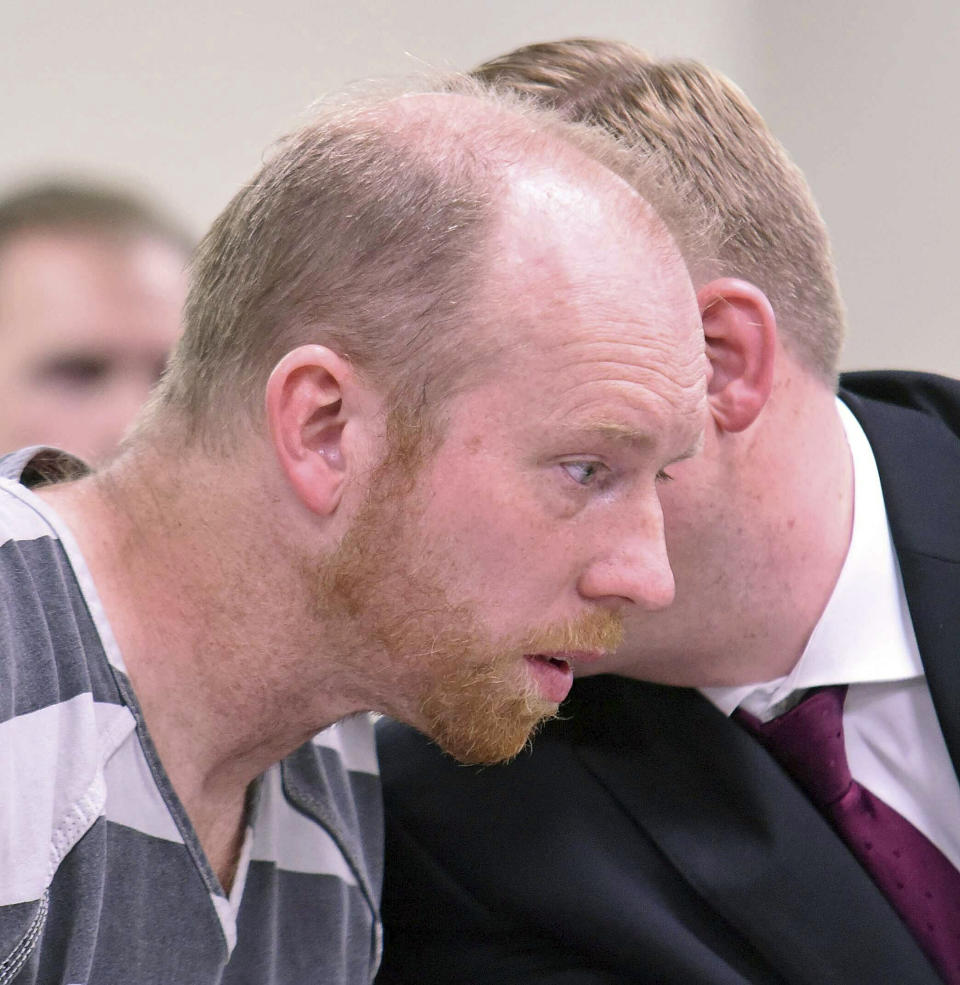 Chad Isaak listens to counsel in district court while being charged with four counts of class AA felony murder in district court on Friday, April 5, 2019, in Mandan, N.D. Isaak was arrested in Washburn on Thursday and charged with murdering four people in Mandan on Monday. He is being held on one million dollars bail. (Tom Stromme/The Bismarck Tribune via AP)