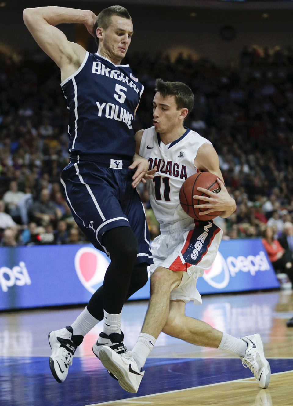 Gonzaga's David Stockton (11) drives against BYU's Kyle Collinsworth (5) in the first half of the NCAA West Coast Conference tournament championship college basketball game, Tuesday, March 11, 2014, in Las Vegas. (AP Photo/Julie Jacobson)