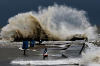 <p>Sydney Schultz takes photos of waves crashing next to Rollover Pass as Tropical Storm Cindy approaches the coast Wednesday, June 21, 2017 on the Bolivar Peninsula, Texas. (Photo: Michael Ciaglo /Houston Chronicle via AP) </p>