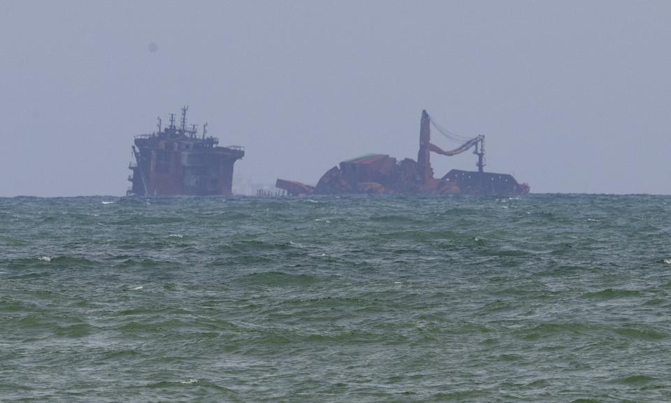 Fire-damaged container ship MV X-Press Pearl is seen partially sunk where it is anchored off Colombo port at Kapungoda, Sri Lanka, Friday, June 4, 2021. The Singapore-flagged ship started sinking Wednesday, a day after authorities extinguished a fire that raged on the vessel for 12 days. (AP Photo/Eranga Jayawardena)