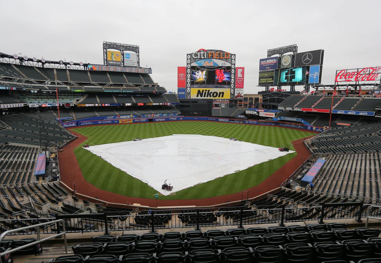 The tarp covered the infield portion of Citi Field for much of the day as rain delayed the start of the Brewers' game against the Mets by 2 hours and 42 minutes Friday.