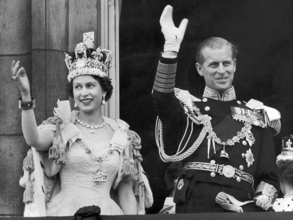 The Queen and the Duke of EDINBURGH wave from the famous balcony at Buckingham Palace to the vast crowds massed outside the Palace on June 2 1953 upon their return from Westminster Abbey after the coronation of the Queen