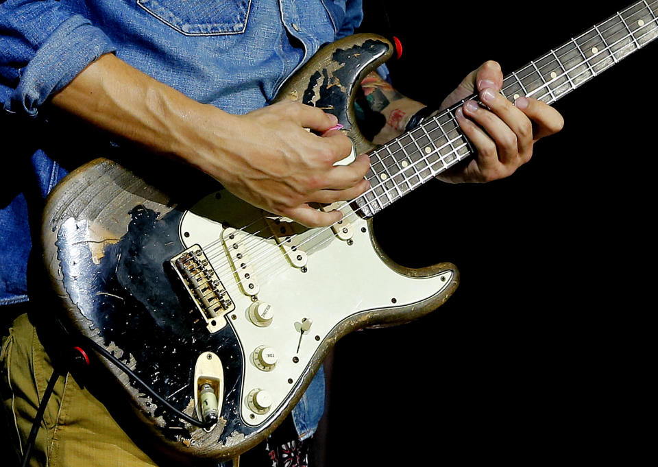 John Mayer performs with his Fender Stratocaster electric guitar in Phoenix on Thursday, Oct. 3, 2013. When asked how the Stratocaster has shaped his creative process, he says, "It's the machine of my dreams. It's the Ford Mustang, the Marilyn Monroe, the lightning rod, surfboard, magic carpet for music." The iconic instrument, used by countless professional and amateur musicians, celebrates its 60th anniversary in 2014. (AP Photo/Matt York)