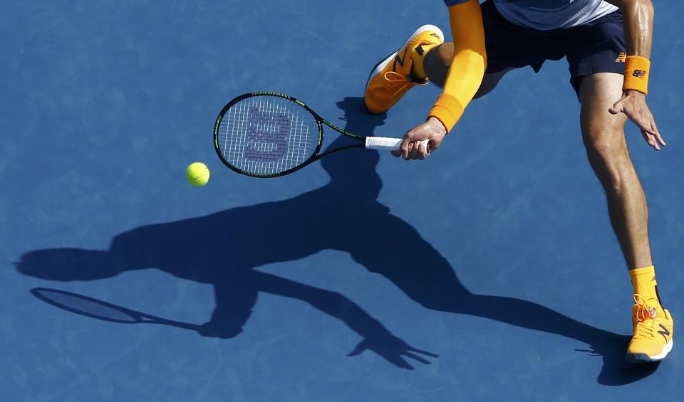 Canada's Milos Raonic casts a shadow as he hits a shot during his fourth round match against Switzerland's Stan Wawrinka at the Australian Open tennis tournament at Melbourne Park, Australia, January 25, 2016. REUTERS/Jason Reed