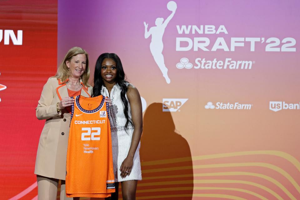 Michigan State's Nia Clouden, right, poses for a photo with commissioner Cathy Engelbert after being selected by the Connecticut Sun as the 12th overall pick in the WNBA basketball draft, Monday, April 11, 2022, in New York.