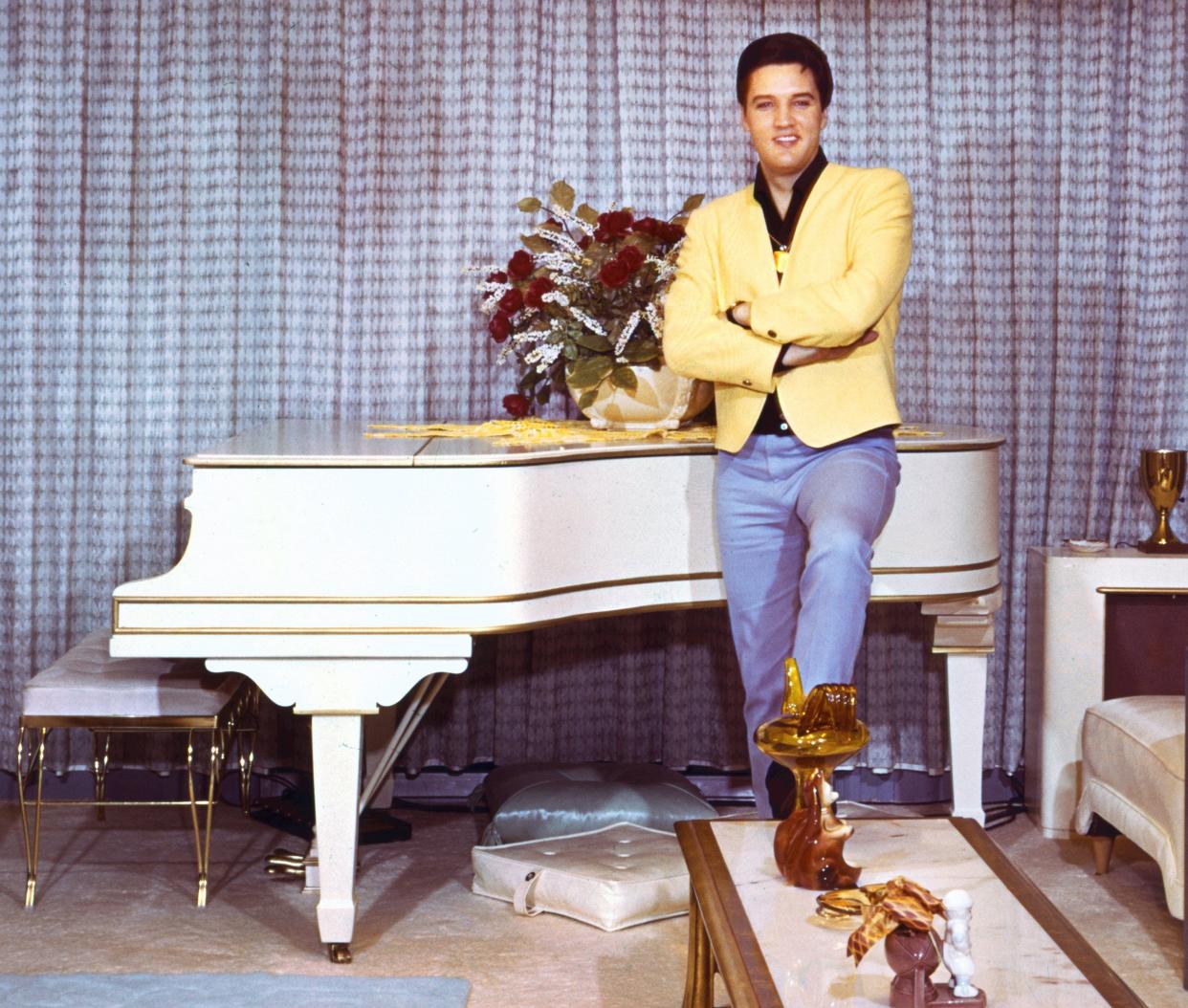 Elvis Presley stands beside his piano at Graceland in this 1965 photograph. Elvis had misgivings about allowing pictures to be taken in his home. "It's not that I don't want pictures," he said. "You know what I mean. Some people might think I am looking for publicity or trying to exploit my home. I certainly don't want anyone to think that."