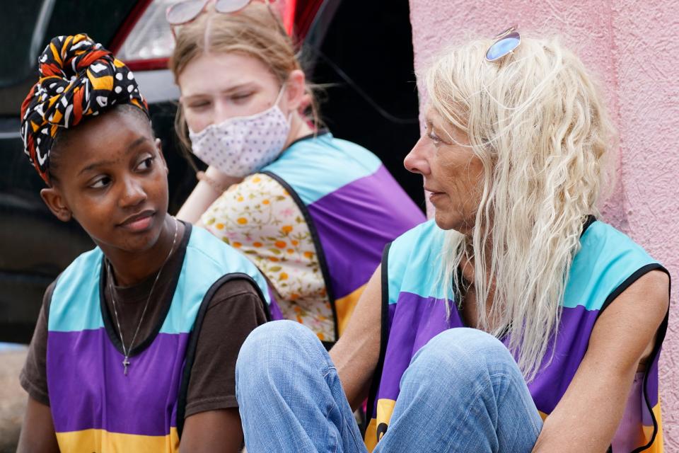 In a file photo, veteran clinic escort Derenda Hancock, right, confers with younger defenders Asia Brown, left, and Ellie Rome, center, as they wait outside the Jackson Women's Health Organization clinic parking lot for patients, Thursday, May 20, 2021, in Jackson, Miss. The clinic is Mississippi's only state-licensed abortion facility. The U.S. Supreme Court agreed to take up the dispute over a Mississippi ban on abortions after 15 weeks of pregnancy. The issue is the first test of limits on abortion access to go before the conservative majority high court. Their decision could mean more restrictions and focuses on the landmark 1973 ruling in Roe v. Wade, which established a woman's right to an abortion. (AP Photo/Rogelio V. Solis)