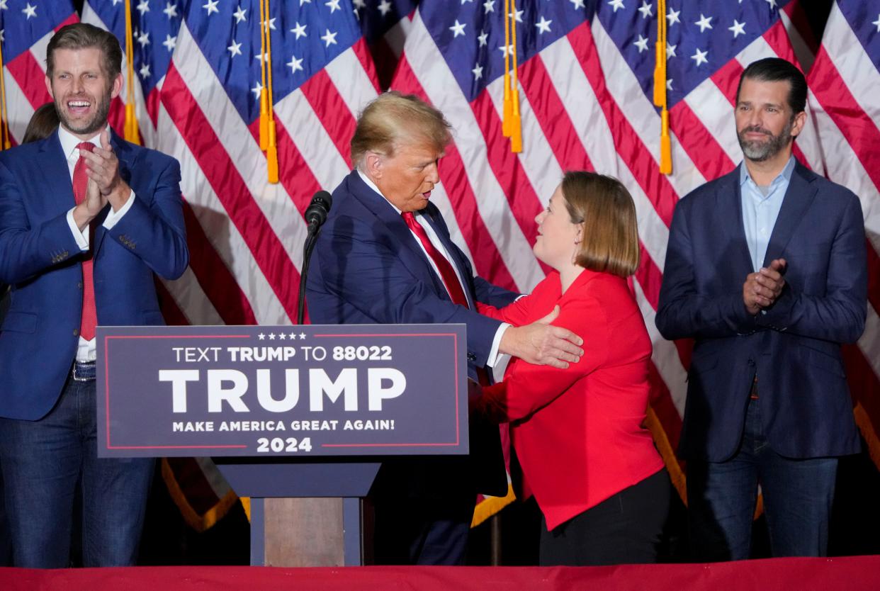 Former President Donald Trump embraces Iowa Attorney General Brenna Bird on Jan. 15 at the Trump caucus night watch party at the Iowa Events Center in Des Moines.