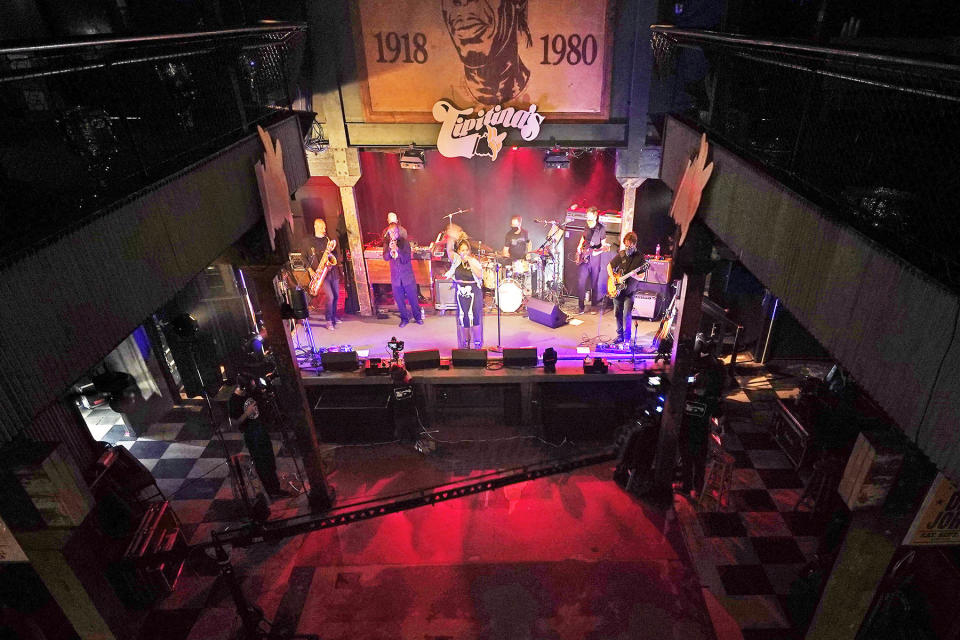 In this Oct. 26, 2020, photo, production engineers record the band Galactic for a video stream concert, inside an empty Tipitina's music club, which the band owns, in New Orleans. 