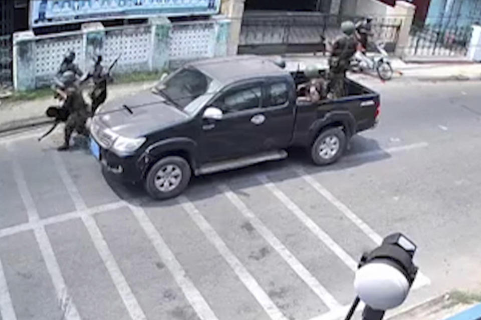 In this March 27, 2021 image from video obtained by The Associated Press, 17-year old Kyaw Min Latt is carried by security forces after a soldier aimed, then fired his rifle towards him and two companions who were riding a motorbike in Dawei, Myanmar. The teenager later died, and his father said army doctors wanted to perform an autopsy. The family fought against it but said the hospital would not release the body until they agreed to sign a paper saying Kyaw Min Latt’s death was caused by head injuries sustained after falling from the motorbike. (AP Photo)