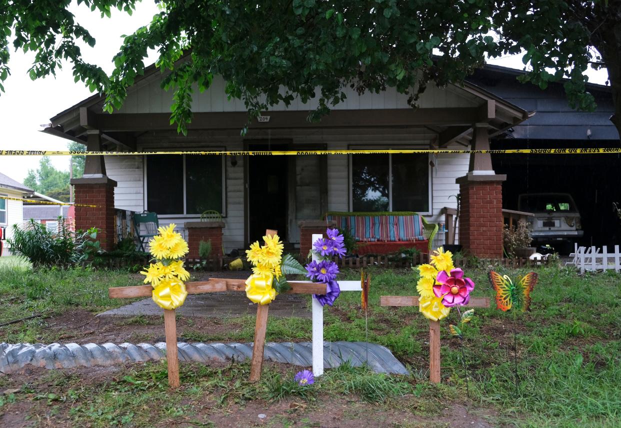 A small memorial is pictured Monday at the scene at 304 S Oak in Crescent, where a house fire Sunday killed three children. The cause of the fire is still under investigation.