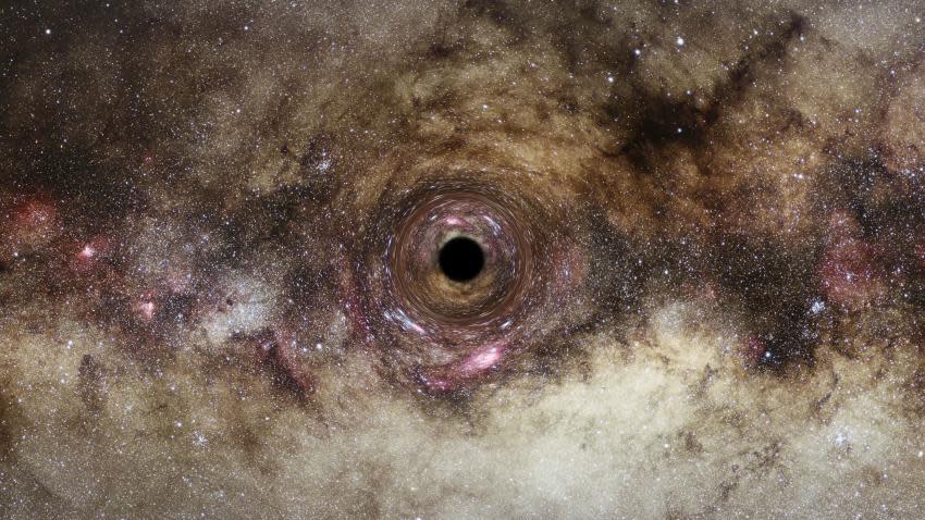  An artist’s impression of a black hole, where the black hole’s intense gravitational field distorts the space around it.  