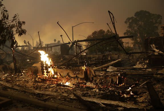 Flames rise from the remains of a burnt-down commercial building in Santa Rosa, California  on October 9, 2017