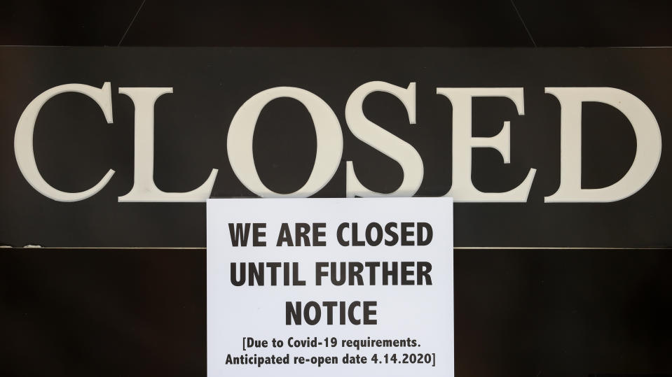 A notice of closure is posted at The Great Frame Up in Grosse Pointe Woods, Mich., Thursday, April 2, 2020. The coronavirus COVID-19 outbreak has triggered a stunning collapse in the U.S. workforce with millions of people losing their jobs in the past two weeks and economists warn unemployment could reach levels not seen since the Depression, as the economic damage from the crisis piles up around the world. (AP Photo/Paul Sancya)