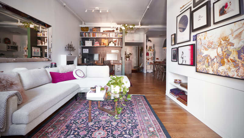 White sectional in art filled living room.