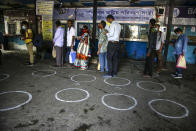 People stand in a queue to book bus tickets to travel to places outside the state in Kolkata, in the eastern Indian state of West Bengal, Wednesday, June 3, 2020. More states opened up and crowds of commuters trickled onto the roads in many of India's cities on Monday as a three-phase plan to lift the nationwide coronavirus lockdown began despite an upward trend in new infections. (AP Photo/Bikas Das)