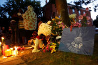 People embrace near a memorial for Abdirahman Abdi, a Somali immigrant to Canada who died after being hospitalized in critical condition following his arrest by Canadian police, in Ottawa, Ontario, Canada, July 26, 2016. REUTERS/Chris Wattie